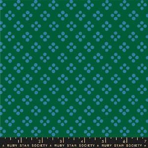 May include: Green fabric with a repeating pattern of four blue dots arranged in a square. The fabric has a ruler along the bottom edge with the text "RUBY STAR SOCIETY".