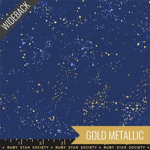 May include: Wideback fabric with a navy blue background and a scattered pattern of gold and blue metallic speckles. The text "GOLD METALLIC" is displayed on a gold banner. The text "WIDEBACK" is displayed on a black banner.
