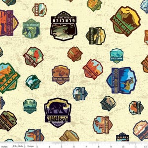 May include: A cream-colored fabric featuring a repeating pattern of colorful national park patches. The patches display park names like Yosemite, Glacier, and Rocky Mountain, with illustrations of landscapes and wildlife. The fabric is ideal for quilting or crafting.