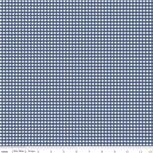 May include: A fabric featuring a classic navy blue and white gingham check pattern. A white ruler is visible at the bottom edge, showing a scale of 12 inches. The text "Riley Blake Designs" is printed on the ruler near the left side.