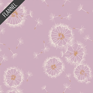 May include: A light purple flannel fabric featuring a repeating pattern of white dandelion seed heads with tan centers and scattered seeds. The word "FLANNEL" is printed in white on a black diagonal banner in the upper left corner.