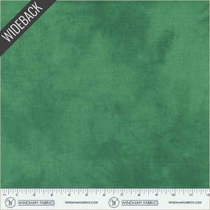 May include: A solid emerald green fabric with a subtle texture. The fabric is marked "WIDEBACK" in a black diagonal banner. The bottom edge features a ruler with inch measurements and the "WINDHAM FABRICS" logo.