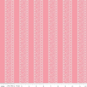 May include: Pink fabric with vertical white lace-like stripes. The stripes feature floral and scroll patterns. The fabric is measured in inches, with a scale from 1 to 12 inches along the bottom edge. The brand name "Riley Blake Designs" is visible.