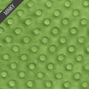 May include: A close-up of a soft, green minky fabric with a textured, dotted pattern. The fabric is commonly used for blankets, baby clothes, and other soft goods.