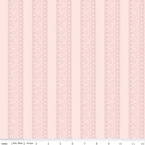 May include: A fabric with a repeating vertical pattern of pink lace-like borders on a light pink background. The borders are detailed with floral and scroll designs. The fabric is measured in inches.