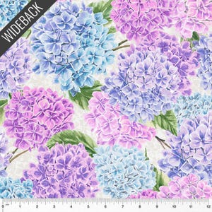 May include: Fabric with a floral pattern featuring large hydrangea blooms in shades of blue, purple, and pink. The flowers are set against a cream-colored background. The word "WIDEBACK" is printed diagonally across the top left corner.