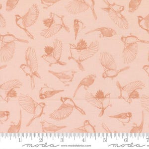 May include: A light peach-colored fabric featuring a repeating pattern of birds in various flight positions and perched poses, rendered in a darker peach line-art style. A white ruler at the bottom shows measurements in inches.