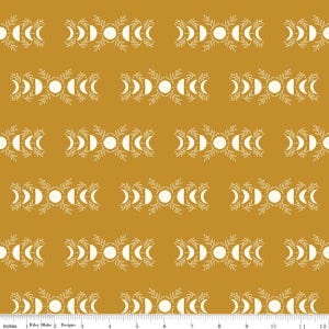 May include: Mustard yellow fabric with a repeating pattern of white crescent moons, circles, and leaves. The design is arranged in horizontal rows, creating a symmetrical and visually appealing textile pattern. The fabric is suitable for various crafting projects.