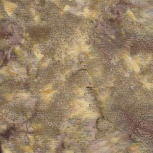 May include: A piece of fabric featuring a mottled, abstract pattern in shades of golden yellow, muted brown, and soft purple. The surface displays a textured, watercolor-like effect with blended color transitions and subtle variations in tone throughout.