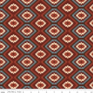 May include: A repeating pattern of diamond shapes in shades of red, beige, and blue. The design has a geometric, Southwestern style, with each diamond containing smaller, detailed shapes. The fabric is likely used for quilting or crafting.