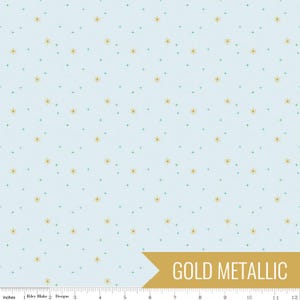 May include: Light blue fabric with a repeating pattern of gold metallic starbursts and small teal crosses. The words "GOLD METALLIC" are printed on a gold banner in the lower right corner. The fabric is measured in inches.