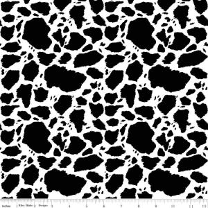 May include: A fabric pattern featuring an irregular black and white cow print design. A white ruler with black markings is visible at the bottom, showing a scale of 12 inches. The repeating pattern consists of various sized black shapes on a white background.