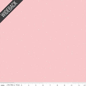 May include: Pink fabric with a scattered white dot pattern. The fabric has the text "WIDEBACK" in a black diagonal banner. The bottom of the fabric has an inch ruler.