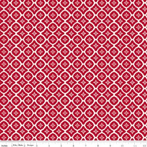 May include: Red and white patterned fabric with a repeating floral design. The fabric has a symmetrical pattern of red quatrefoils with white accents, creating a visually appealing and detailed texture. The image includes a ruler in inches.