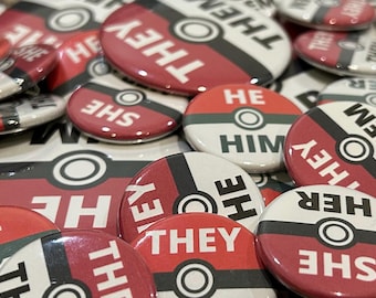 Discounted Seconds Slightly Imperfect Pokeball 1.25 in and 2.25 in Pronoun Buttons