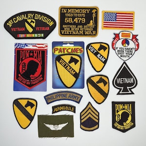 May include: A collection of embroidered military-themed patches featuring various designs including the 1st Cavalry Division, POW-MIA, Vietnam War memorials, the American flag, Philippine Army insignia, and various chevron and horse-head emblems.