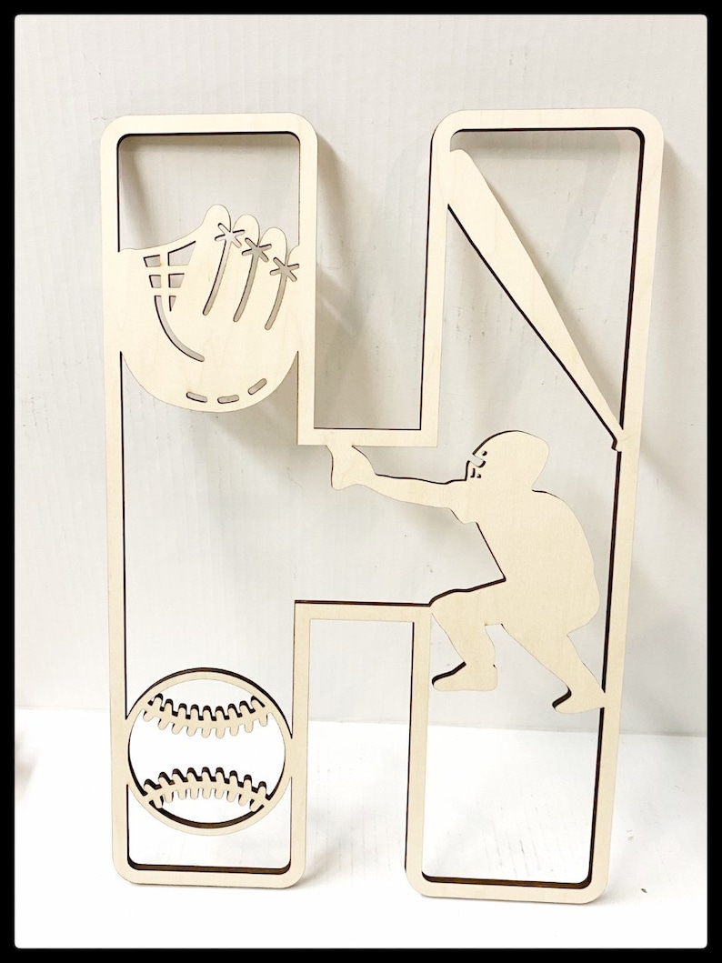 May include: Wooden cutout of the letter H with a baseball player, bat, glove, and baseball inside the letter.