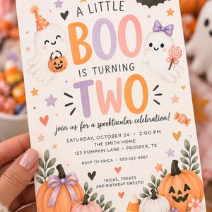 May include: A rectangular Halloween-themed birthday invitation card featuring two cartoon ghosts, pumpkins, and stars. The text reads: A LITTLE BOO IS TURNING TWO, join us for a spooktacular celebration, Saturday, October 24, 2:00 PM, The Smith Home, 123 Pumpkin Lane, Prosper, TX, RSVP to Erica 555-123-4567, Tricks, Treats and Birthday Sweets.