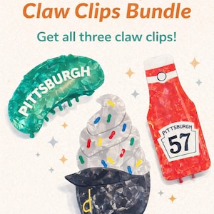 May include: A bundle of three claw hair clips. One is green with "PITTSBURGH" in white, another is a cupcake design with sprinkles, and the last is a red ketchup bottle with "PITTSBURGH 57". The text "Pittsburgh Claw Clips Bundle" is at the top.