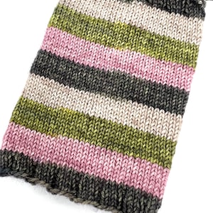 May include: A knitted fabric swatch with stripes in shades of green, pink, brown, and beige.
