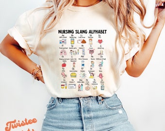 May include: A white t-shirt with a graphic of a nursing slang alphabet. The alphabet is illustrated with icons and text. The text includes abbreviations like ABH codal, Banana bay, Code brown, Dyscopia, and more.