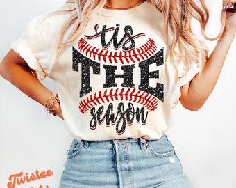 May include: A white t-shirt with a black and red baseball graphic and the text "'tis the season".