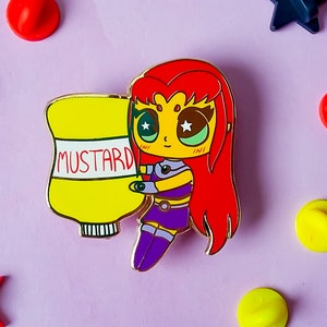 May include: A red-haired cartoon character with large eyes and a mustard bottle. The character is wearing a purple and gold outfit and is holding the mustard bottle. The character is a pin.