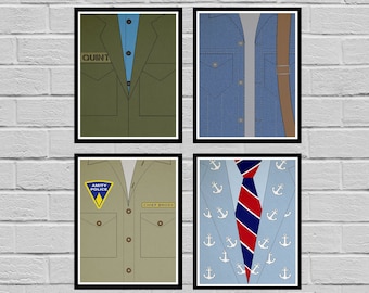 May include: Four printable posters featuring different outfits from the movie Jaws. The posters are black framed and feature a green jacket with the word "Quint" on it, a blue denim jacket, a khaki shirt with the words "Amity Police" and "Chief Brody" on it, and a blue blazer with a red and blue striped tie and an anchor pattern.