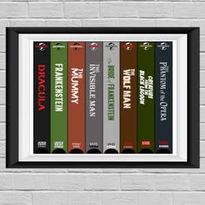 May include: Framed print featuring a collection of classic Universal Monsters VHS tapes. Titles include "Dracula," "Frankenstein," "The Mummy," and "The Phantom of the Opera." The tapes are arranged vertically with a black frame.
