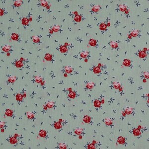May include: A green fabric with a repeating pattern of small pink and red roses.