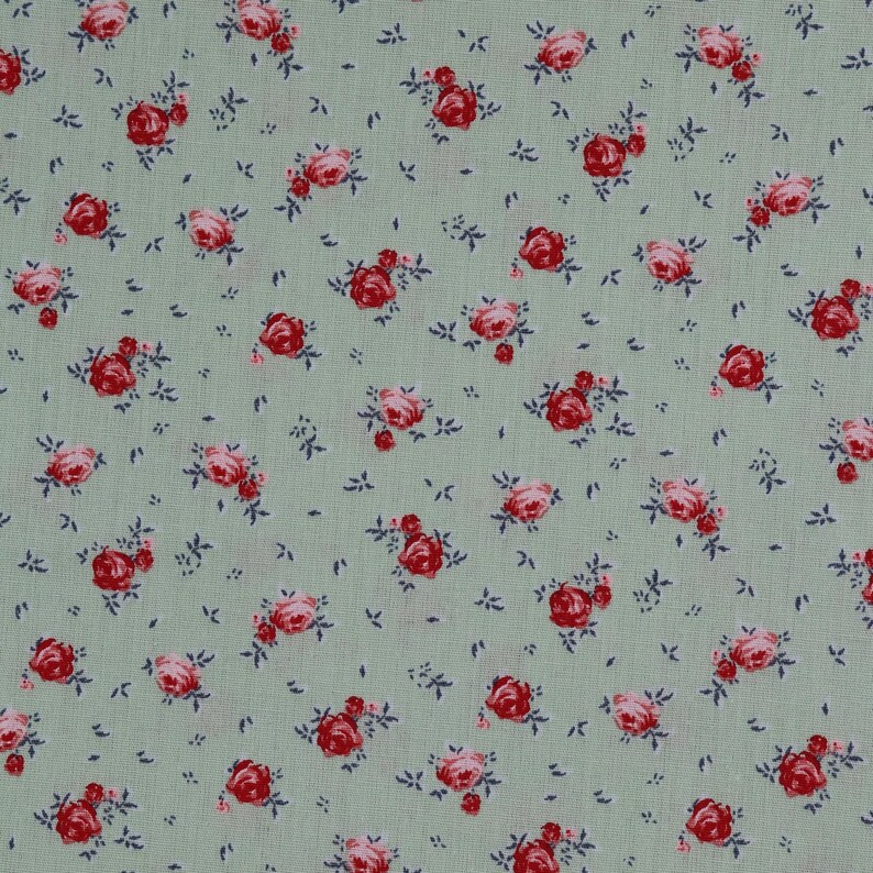 May include: A green fabric with a repeating pattern of small pink and red roses.