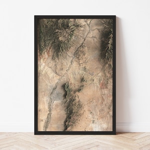 May include: A framed aerial photograph of a desert landscape with a large mountain range in the center. The photograph is in shades of brown, tan, and green.