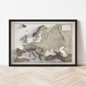 May include: A vintage-style map of Europe with a 3D relief effect. The map is printed on a white background with brown and green accents. The map is framed in a black frame.