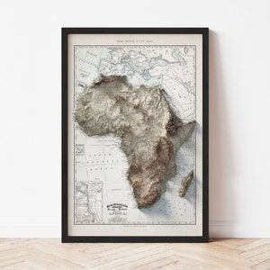 May include: A vintage map of Africa with a 3D embossed effect. The map is printed on white paper with brown and black lines and text. The title of the map is "Rand McNally & Co's Atlas - World Map of AFRICA."