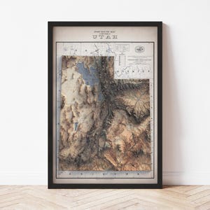 May include: Framed vintage post route map of Utah, featuring a detailed relief of the state's topography. The map is in shades of brown, beige, and blue, with the title "UTAH" at the top. The map is encased in a black frame.