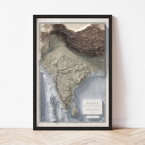 May include: Framed 3D relief map of India, showcasing the country's topography in shades of brown, beige, and blue. The map is set against a white background and framed in black. Includes text: "INDIA" and "ARMY OF INDIA 1844."