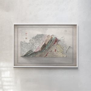 May include: A framed vintage geological map titled The Geology of Virginia, featuring detailed topographical lines and color-coded regions in shades of green, brown, and red, set against a neutral background within a simple white frame.