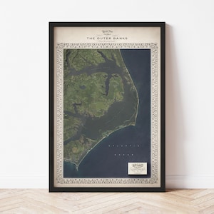 May include: A vintage-style map of The Outer Banks, North Carolina, with a detailed illustration of the coastline and surrounding waters. The map is framed in black and has a decorative border.