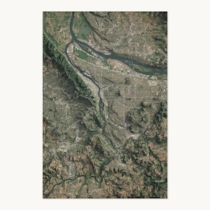 May include: A high-altitude satellite view of a landscape featuring a winding river flowing through a valley. The terrain displays a mix of dark green forested hills, brown earth, and urban areas with gray road networks and building clusters.