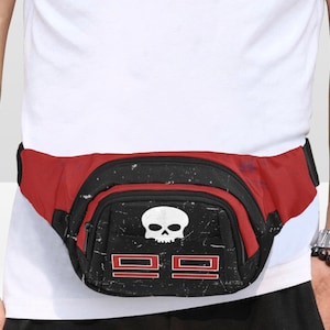 May include: Red and black fanny pack with a skull graphic and the number 99. The fanny pack has a zippered main compartment and an adjustable strap. The design has a distressed, vintage look.