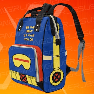 May include: Blue backpack with a yellow and red design featuring a character with a mask and the text "Be the best at what you do".
