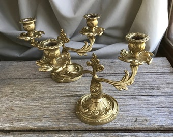 A pair of beautifully cast antique delicate  French bronze candlesticks candle holders with rococo details.