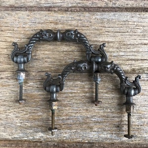 Antique  patinated cupboard pulls or drawer handles in a classic design - pair of  knobs with fixing bolts attached.