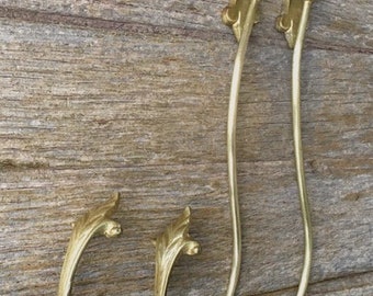 A pair of French classical empire design antique decorative bronze swan neck curtain holdbacks with a gilt ormolu finish