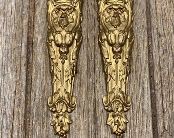 A pair of beautifully cast antique bronze decorations with detailed floral motifs for decorating furniture