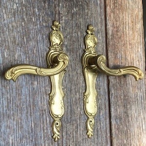 A pair of  gilt bronze door handles  in the rococo style