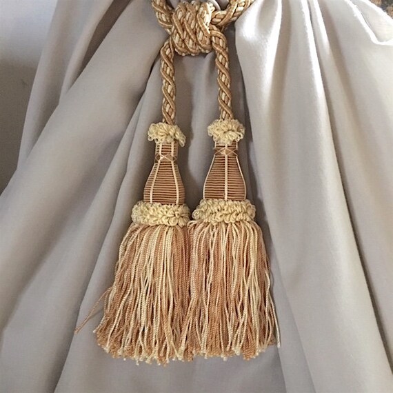 A pair of bespoke twisted cord curtain tie-backs with tassels 