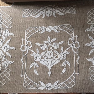 A magnificent antique French re-embroidered hand made filet lace bedspread with fringed borders