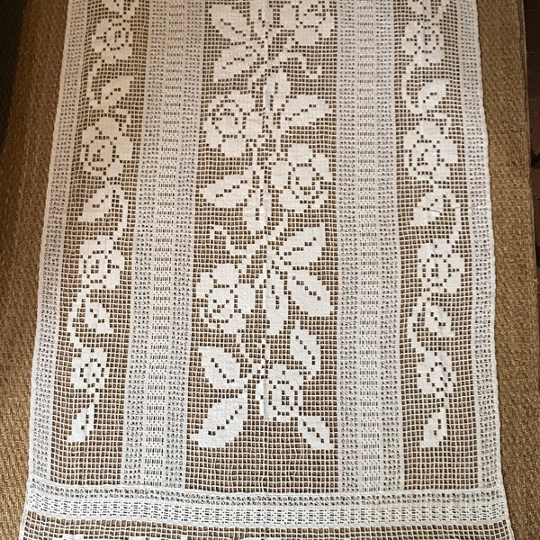 An elegant full length French traditional filet lace length used as a curtain from an estate sale.