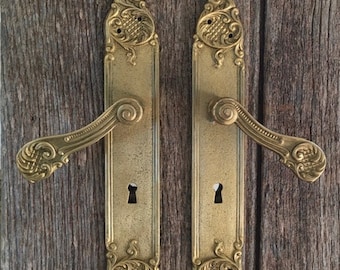 A pair of  gilt bronze door handles  in the rococo style